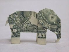 an origami elephant made out of one dollar bill is shown in front of a white background