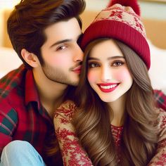 a man and woman sitting next to each other on a bed wearing red hats, sweaters and plaid shirts