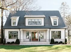 a white house with black roof and windows