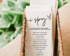 a couple of cards sitting on top of a table next to a basket filled with flowers