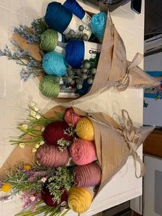 two bags filled with yarn sitting on top of a kitchen counter next to each other