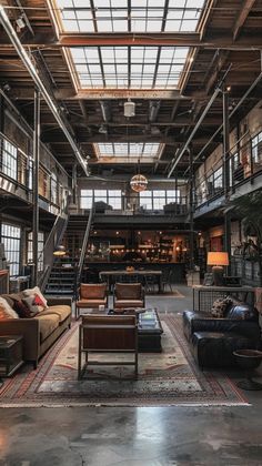 an industrial loft with couches, chairs and tables