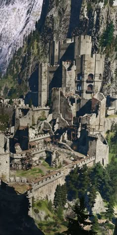 an aerial view of a castle with mountains in the background