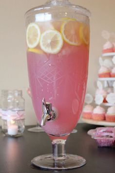 a glass filled with pink liquid and lemon slices