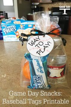 some snacks are wrapped in plastic bags and sitting on a table with the words game day snacks baseball tags printable