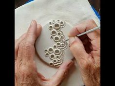 an older person is working on some artwork