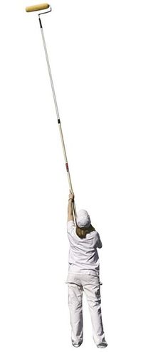 a person in white is holding onto a pole with a broom on it's head