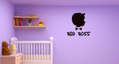 a baby's room with purple walls and a big boss wall decal on the wall