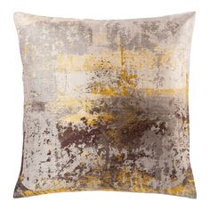 a decorative pillow with yellow and brown paint on it