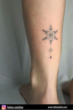 a snowflake tattoo on the leg of a woman's legs is shown