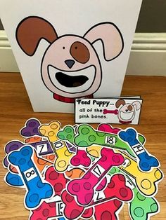 a pile of stickers sitting on top of a wooden floor next to a box