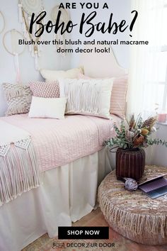 a bed with pink and white pillows on top of it, next to a window