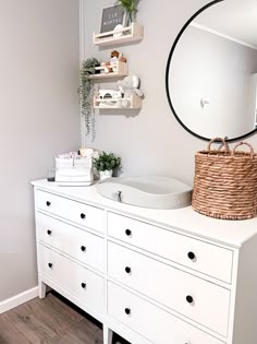 a white dresser and mirror in a room