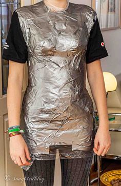 a woman is wearing an aluminum foil dress