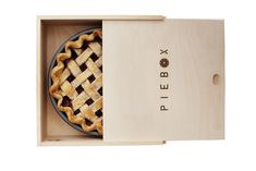 a pie in a wooden box with the lid open