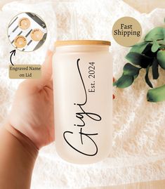 a hand holding a white ceramic cup with writing on it and the words, fast shipping