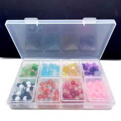 an open plastic box filled with lots of beads and some sort of bead in it