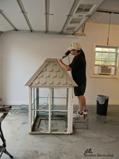 a man is painting the roof of a house