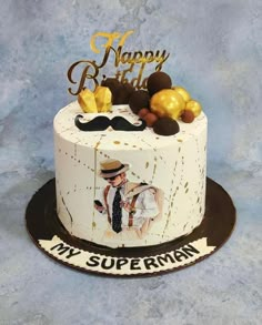 a birthday cake with an image of a man wearing a hat and moustache