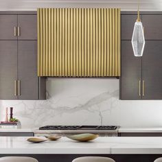 a kitchen with marble counter tops and yellow blinds on the window sill over the stove