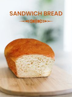 a loaf of bread sitting on top of a wooden cutting board with the words sandwich bread