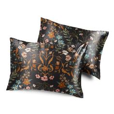 two pillows with floral designs on them, one is black and the other is brown