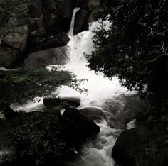 the water is rushing down the rocks in the stream