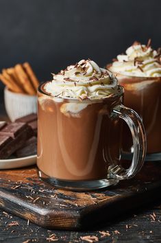 two mugs filled with hot chocolate and whipped cream