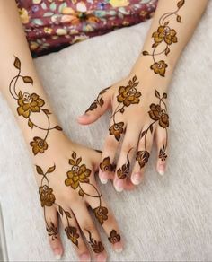 two hands with hendi designs on them