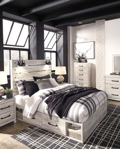 a bedroom scene with focus on the bed, dresser and nightstands that are white