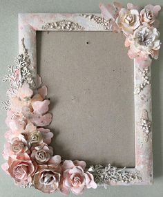 an old photo frame decorated with pink flowers