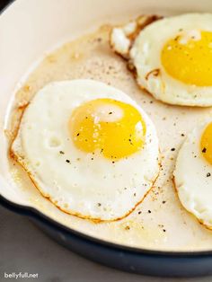 two fried eggs in a skillet on a table