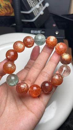 Material:  Arusha sunstone beads  size :  15.5mm hole size 1mm   quantity: one strand  6mm approx 29 pcs one strands 7mm approx25 pcs one strands 8mm approx 22 pcs one strands 9mm approx 21pcs one strands 10mm approx 19 pcs one strands 11mm approx 18pcs one strands 12mm approx 16 pcs one strands 13mm approx 16 pcs one strands 14mm approx 15 pcs one strands 15mm approx 14pcs one strands 16mm approx 14 pcs one strands 17mm approx 13pcs one strands 18mm approx 13pcs one strands 19mm approx 12pcs on Orange Gemstone Beaded Bracelets With Round Beads, Orange Gemstone Beaded Bracelets, Spiritual Orange Crystal Bracelet With Round Beads, Arusha, Beads Bracelets, Women Bracelet, Bracelet Design, Creative Jewelry, Beads Bracelet