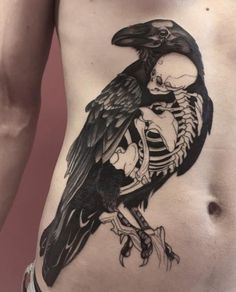 a black and white photo of a person with a skeleton tattoo on their stomach that has a crow sitting on it