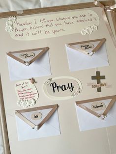 an open envelope with some cards attached to it and the words pray written on it