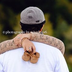 a man carrying a woman on his back while she is holding her arm around him