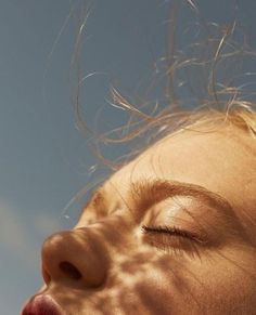 a close up of a person with their eyes closed