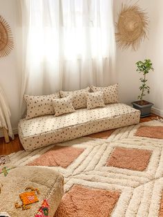 a living room with a couch, rug and window