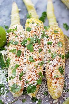 grilled corn on the cob topped with parmesan cheese and cilantro