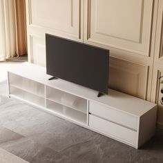 a flat screen tv sitting on top of a white entertainment center