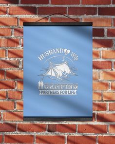 a blue sign on a brick wall that says husband and wife camping partners for life