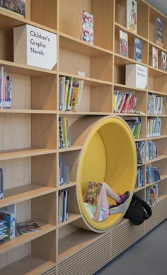 a child's chair in the middle of a bookshelf