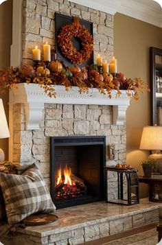 a living room with a fireplace decorated for fall