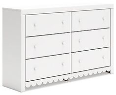 a white dresser with scalloped drawers on the top and bottom, in front of a white background