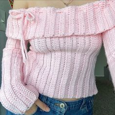 a close up of a person wearing a pink sweater