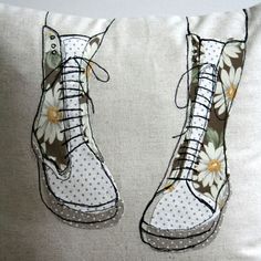 a pair of white boots sitting on top of a pillow