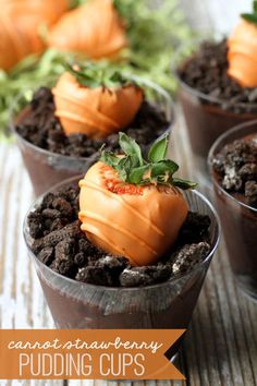 chocolate pudding cups with orange frosting and strawberries on top