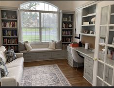 a living room filled with furniture and bookshelves