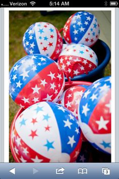 several red, white and blue balloons in a bucket