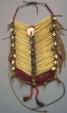 a piece of art made out of sticks and beads